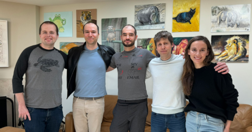 Group of six people smiling for a photo.