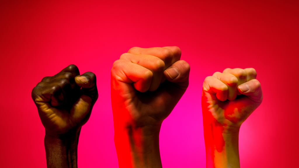 Three fists raised in solidarity.