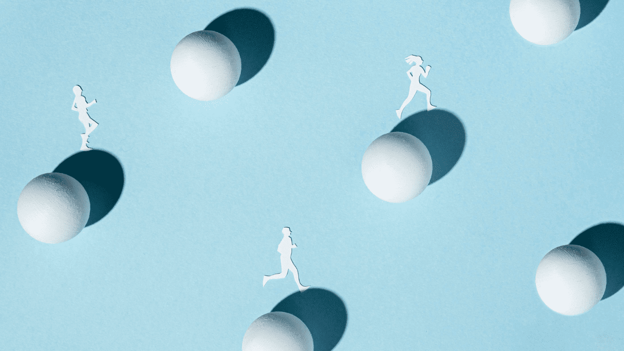 Abstract image of people silhouettes running across giant balls