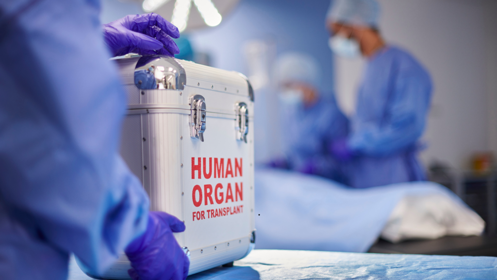 photo of a surgeon holding a steel suitcase with a human organ